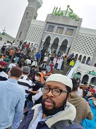 Muslims standing outside a mosque in Korea, showcasing unity and the presence of Islamic culture."