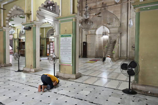 Young Muslim devotee praying at Nakhoda Masjid,